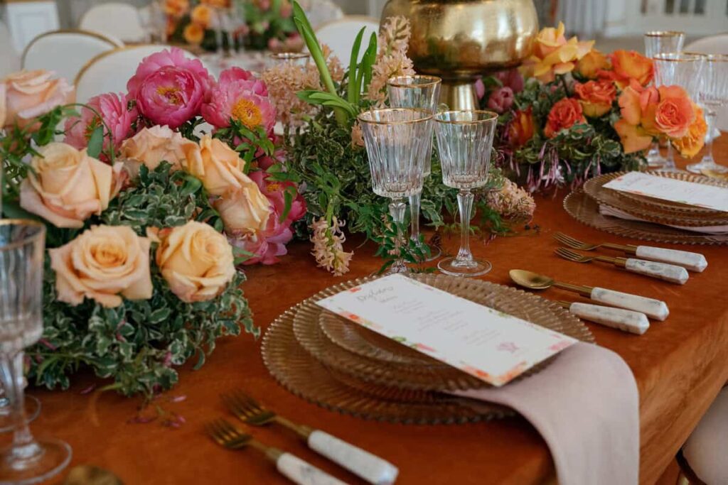 Elegant springtime tablescape with fresh floral centerpieces and pastel blooms at a luxury wedding reception.