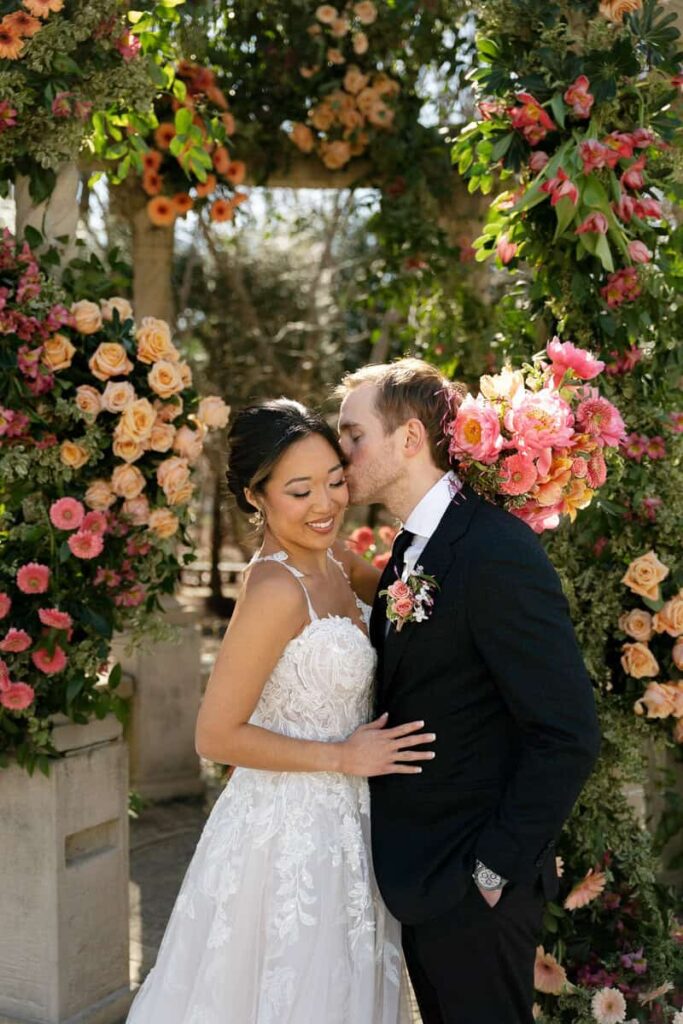 Bride and groom portraits surrounded by fresh florals designed by Intrigue Designs.