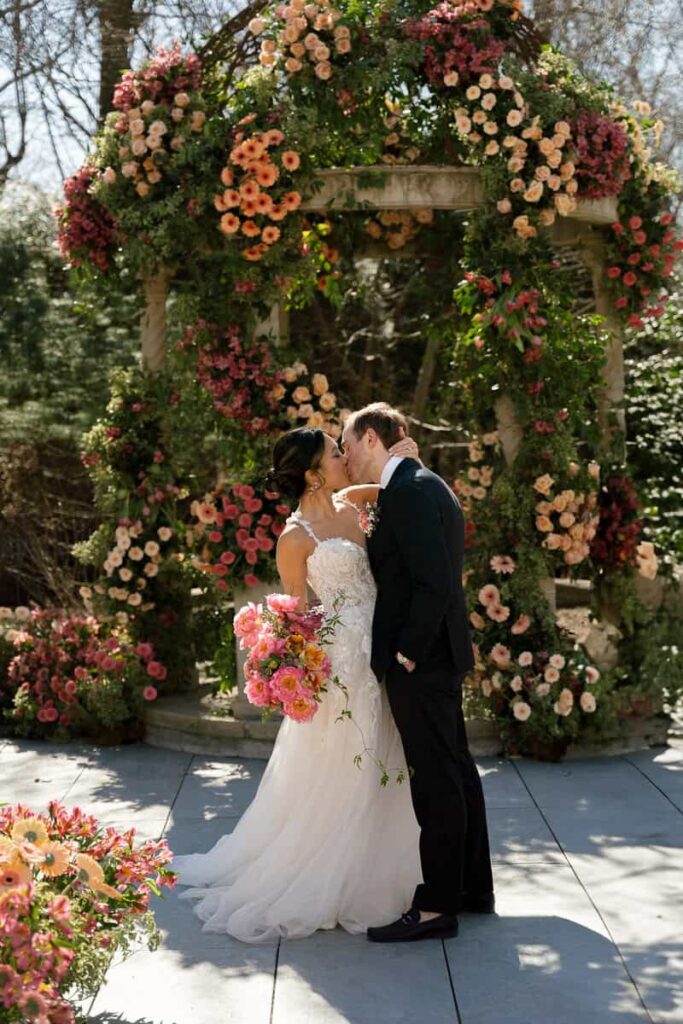 Luxury fresh floral ceremony installation by Intrigue Designs at Crystal Plaza NJ, with romantic garden-style blooms and a dramatic aisle floral design.