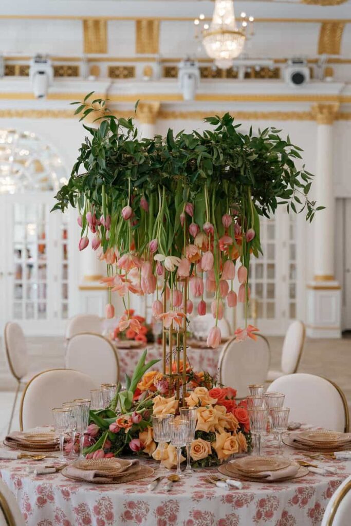 Elegant springtime tablescape with fresh floral centerpieces and pastel blooms at a luxury wedding reception.