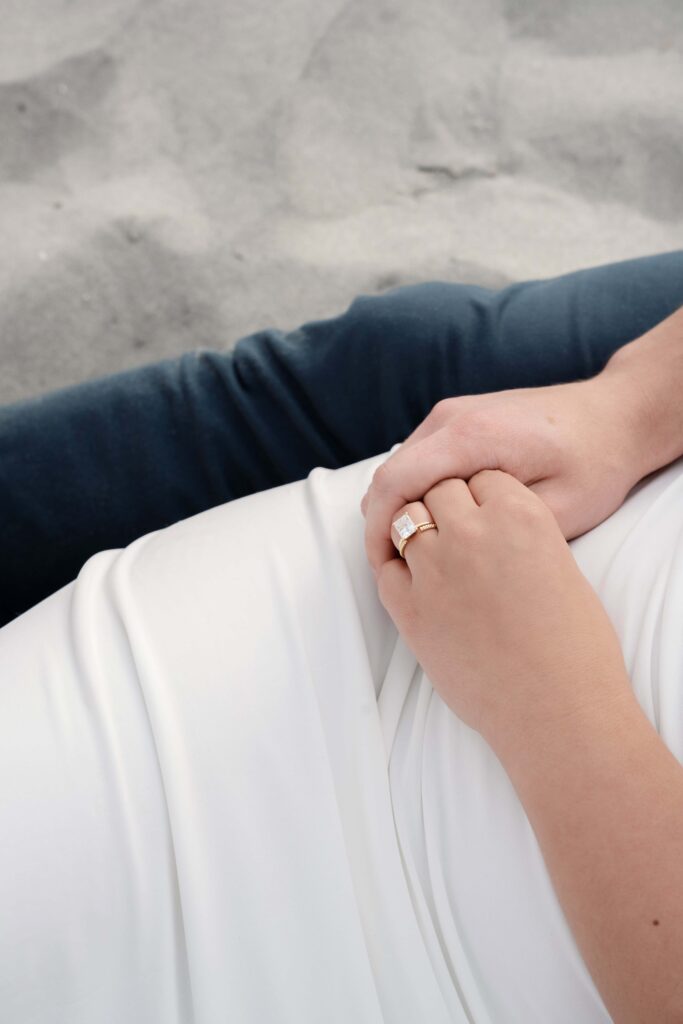 Close up of engagement ring during engagement photos at Folly Beach in Charleston SC.