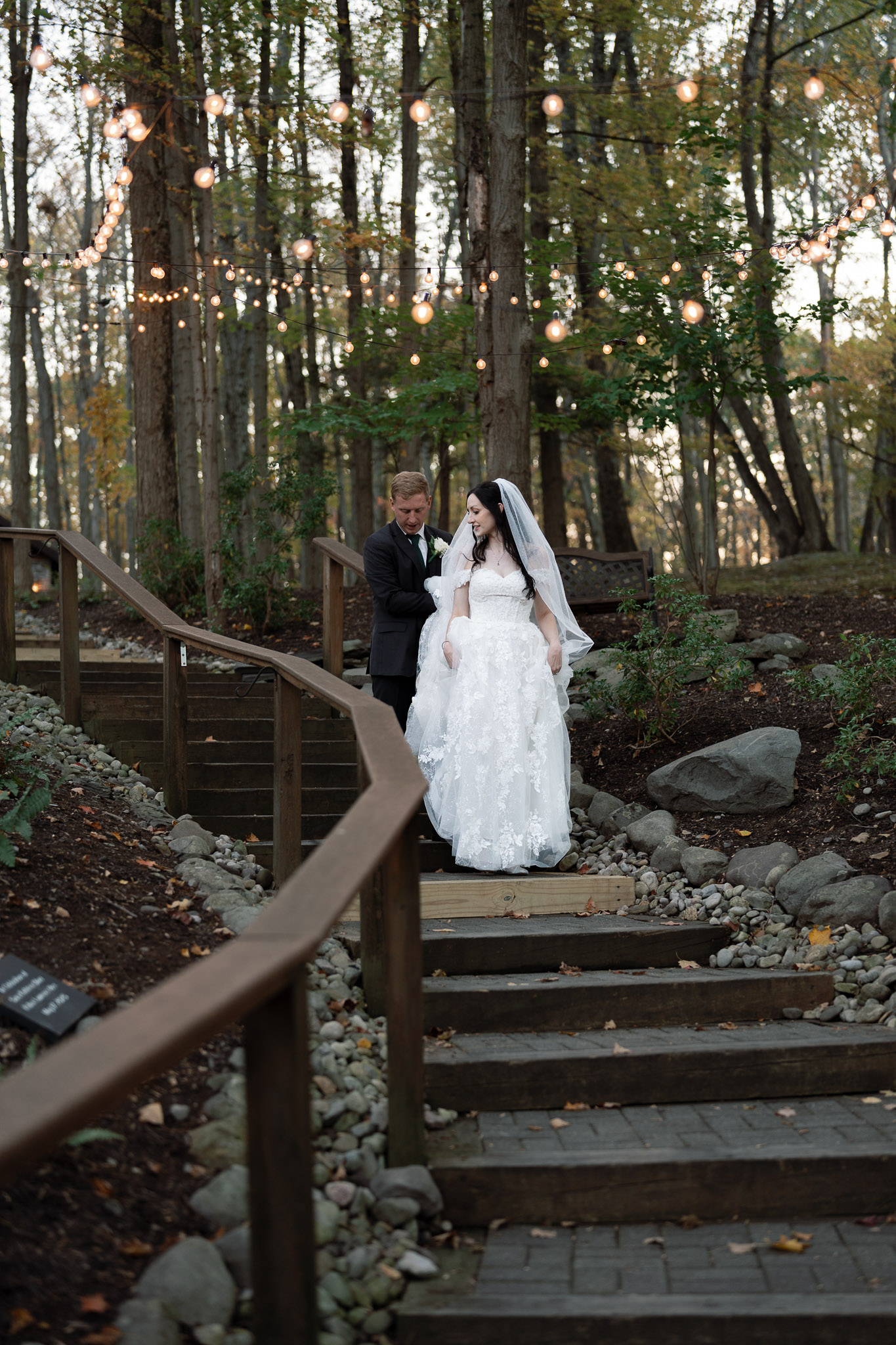 Bride and groom walking down from the woodland chapel at Stroudsmoor Country Inn Woodsgate.